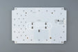 White rectangular led board with black surface mount components and silver solder pads for konami podium belly door