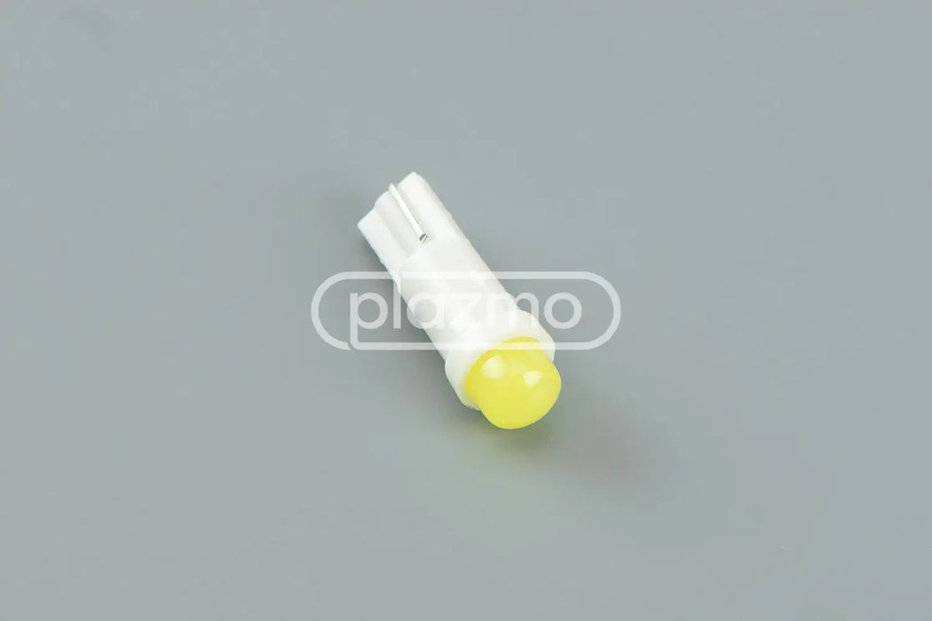 Yellow led indicator lamp with white plastic housing and two metal contacts for 12 volt t5 wedge use