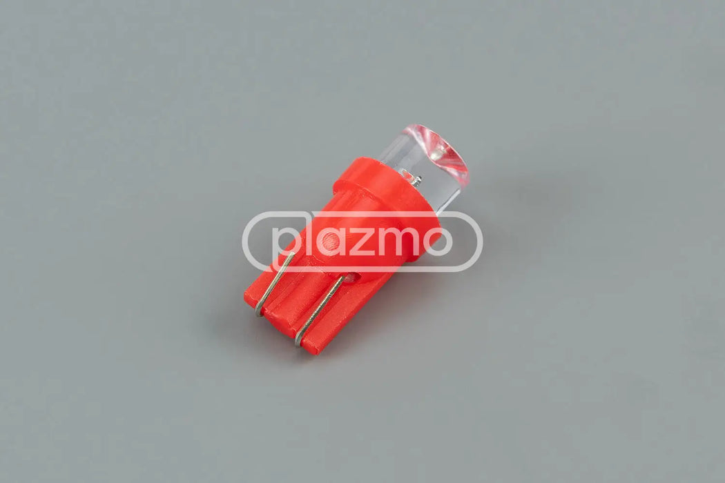 Red plastic wedge led indicator lamp with clear concave lens and three metal contacts for 12 vdc use